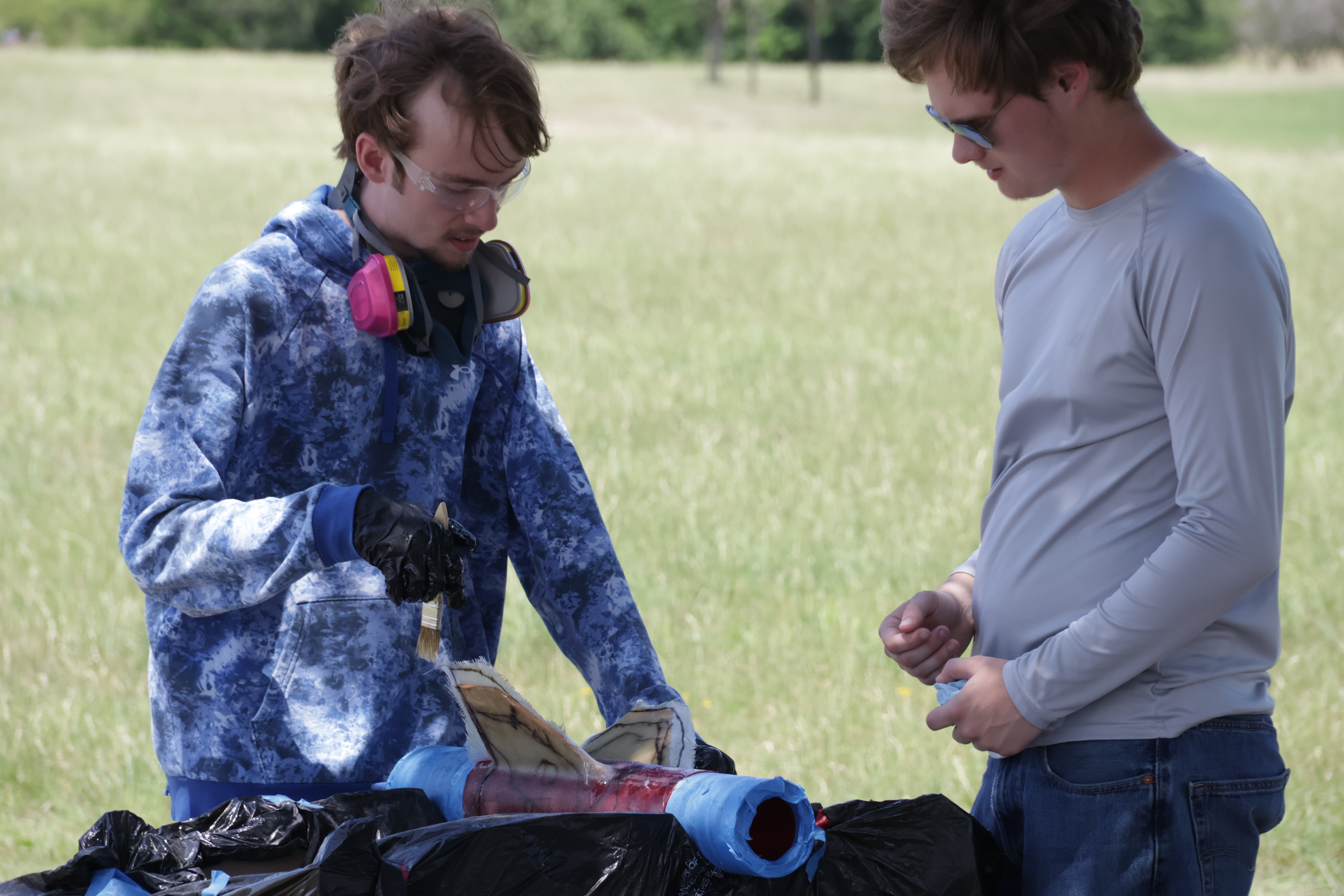 Team members working on a fiberglass airframe